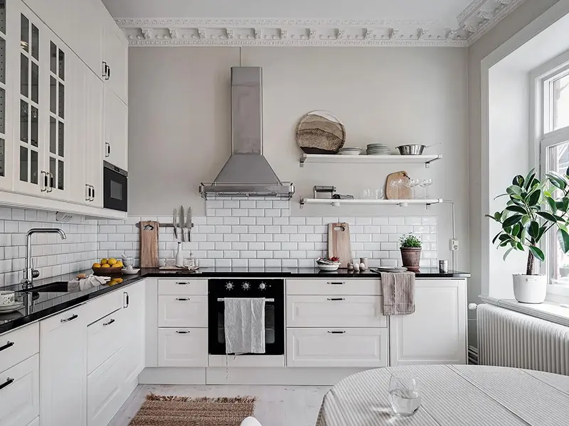 white kitchen cabinets with black countertops