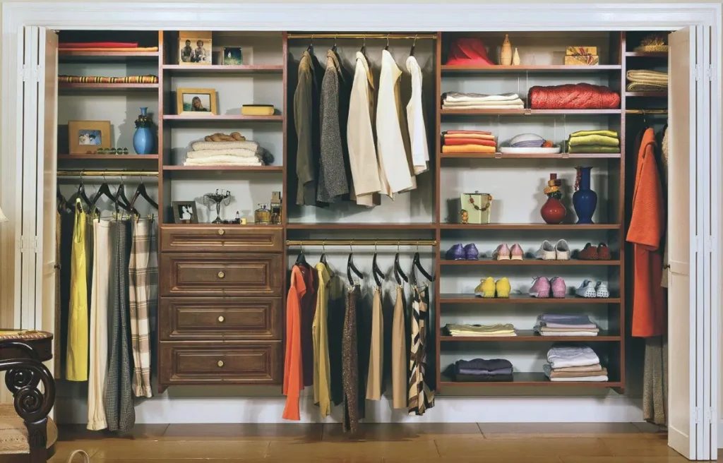 Image of a wooden built-in closet with multiple hanging spaces, drawers and open closets